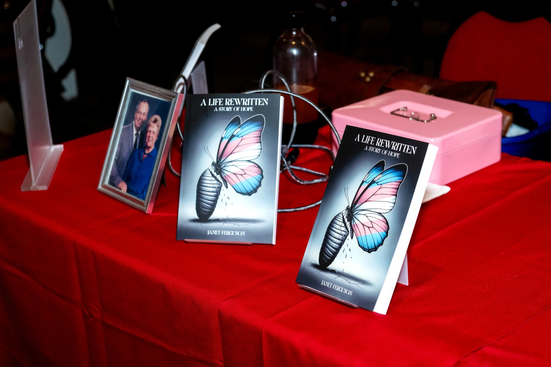 Books on display next to a framed family photograph